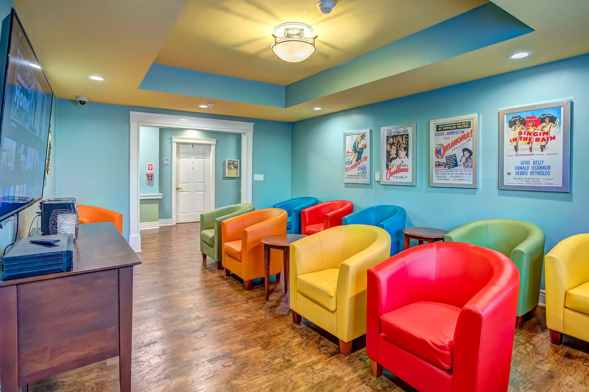 A row of colorful chairs in a room with blue walls.