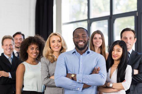 A group of business people are posing for a picture together.