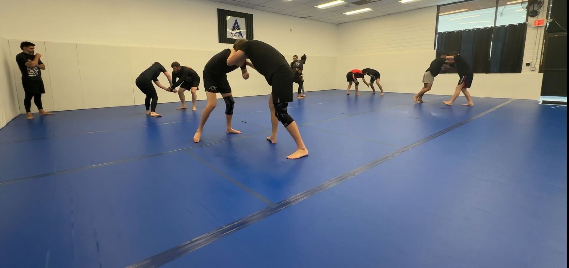 Athletes drilling takedowns at Vacaville Grappling Academy in Vacaville, CA to build conditioning and control.