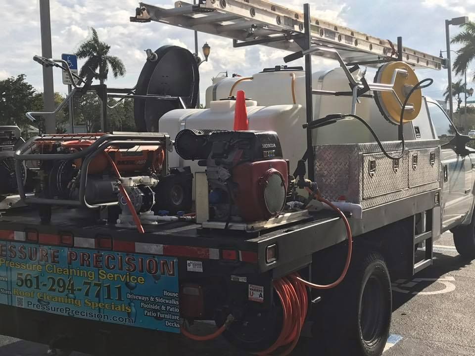 Pressure washing truck with equipment; license plate shows 