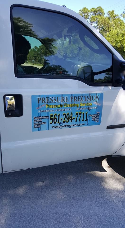 White truck door with a blue sign displaying 