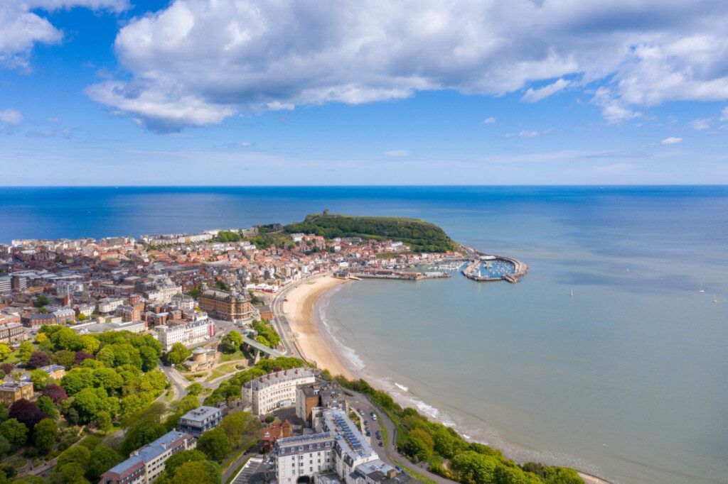 An aerial view of a city and a beach next to the ocean.