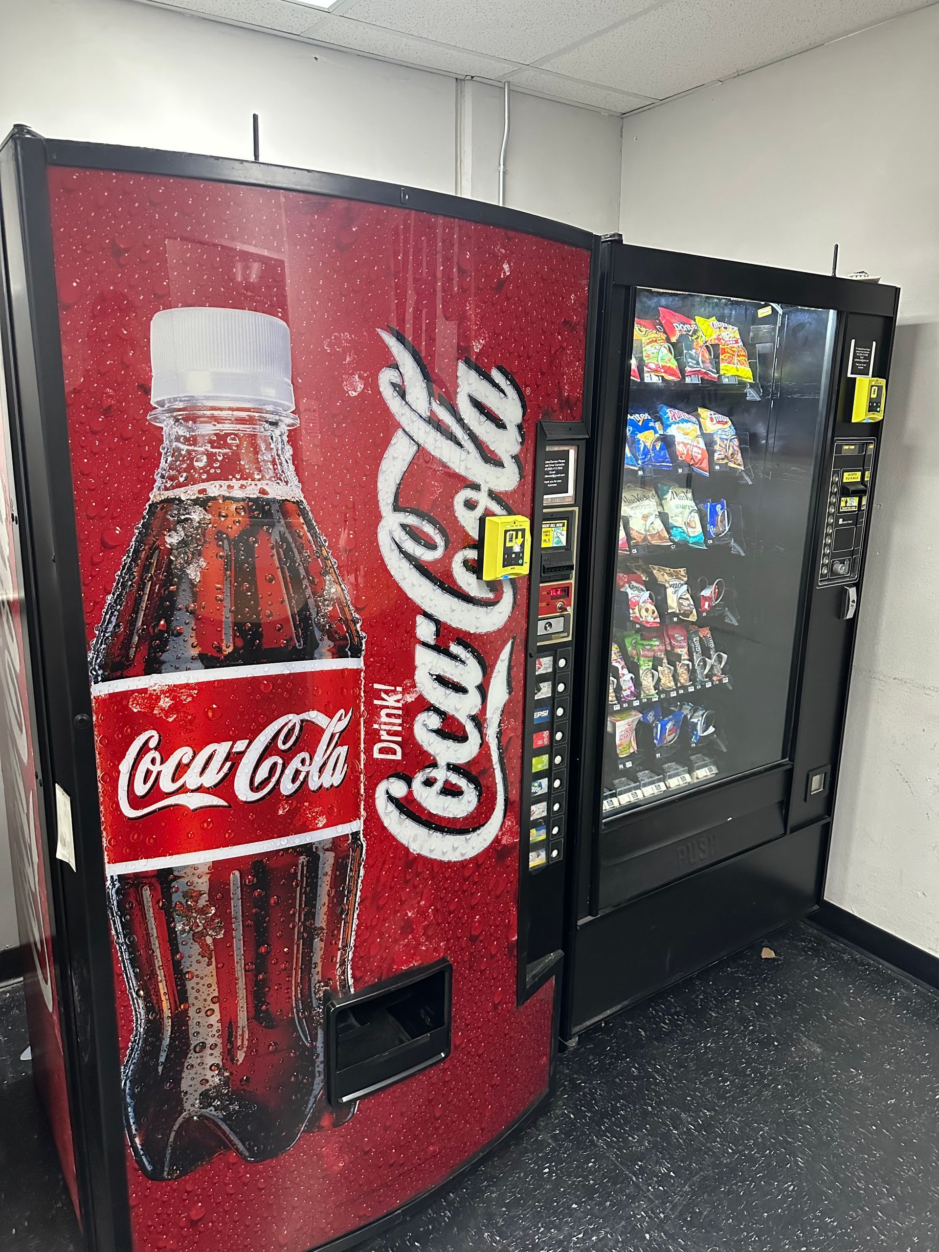 A Person Is Pressing A Button On A Vending Machine.