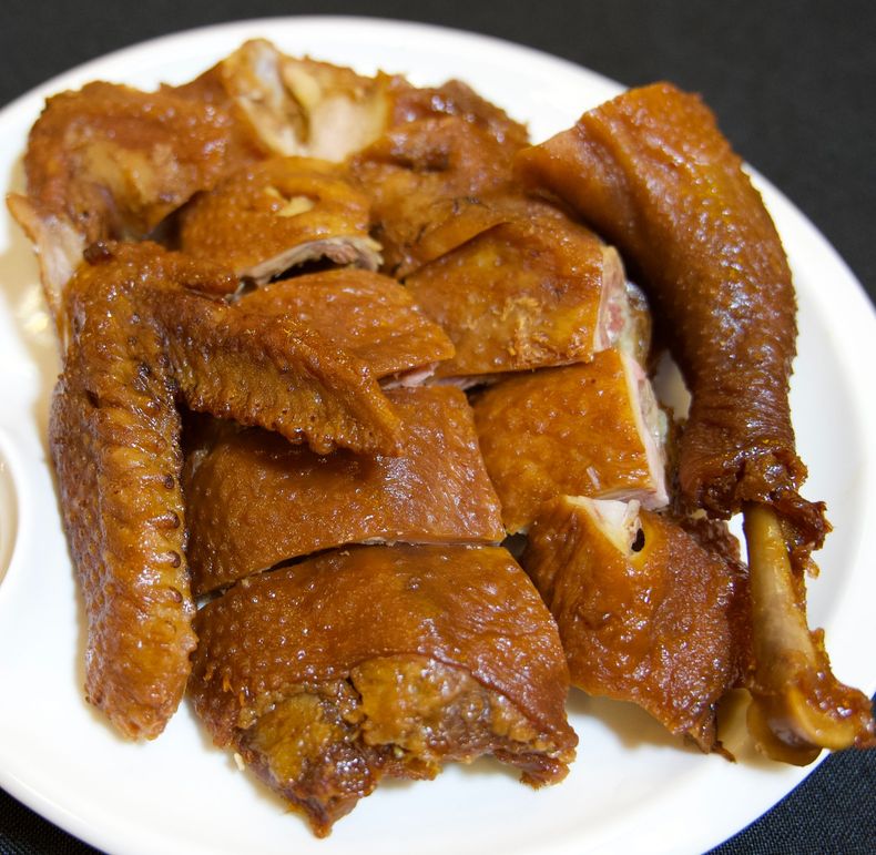 Plate of chopped roasted chicken with golden-brown crispy skin