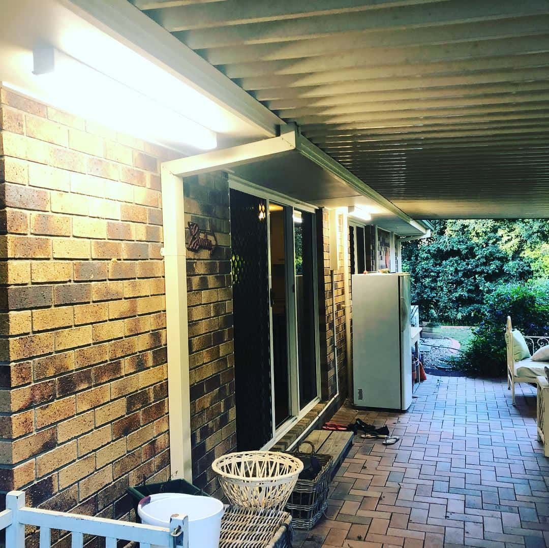 A Brick House with A Covered Porch and A Refrigerator — Higgins Electrical in Beerwah, QLD