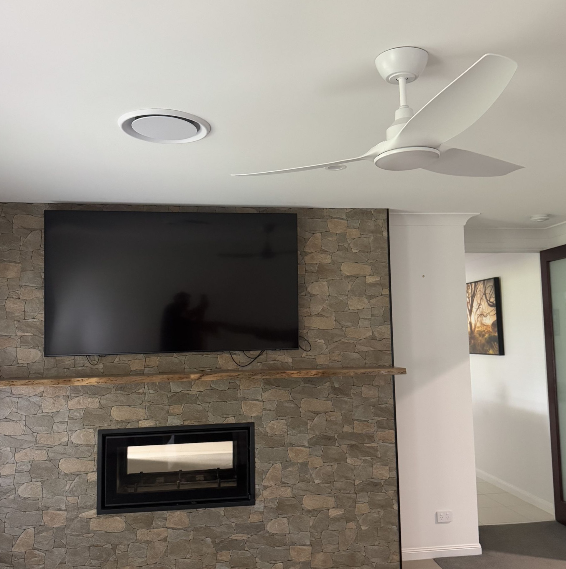 A Ceiling Fan Is Hanging from The Ceiling in A Bedroom — Higgins Electrical in Beerwah, QLD