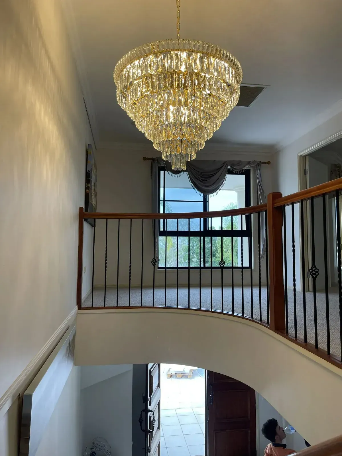 Grand Foyer With a Large Chandelier, Staircase — Higgins Electrical in Aura, QLD