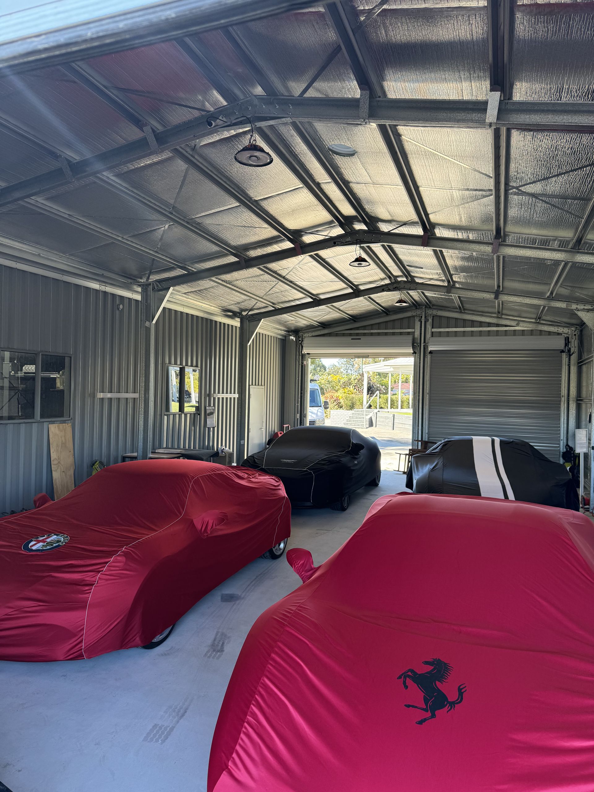 Garage with four cars: all in a metal building — Higgins Electrical in Nambour, QLD
