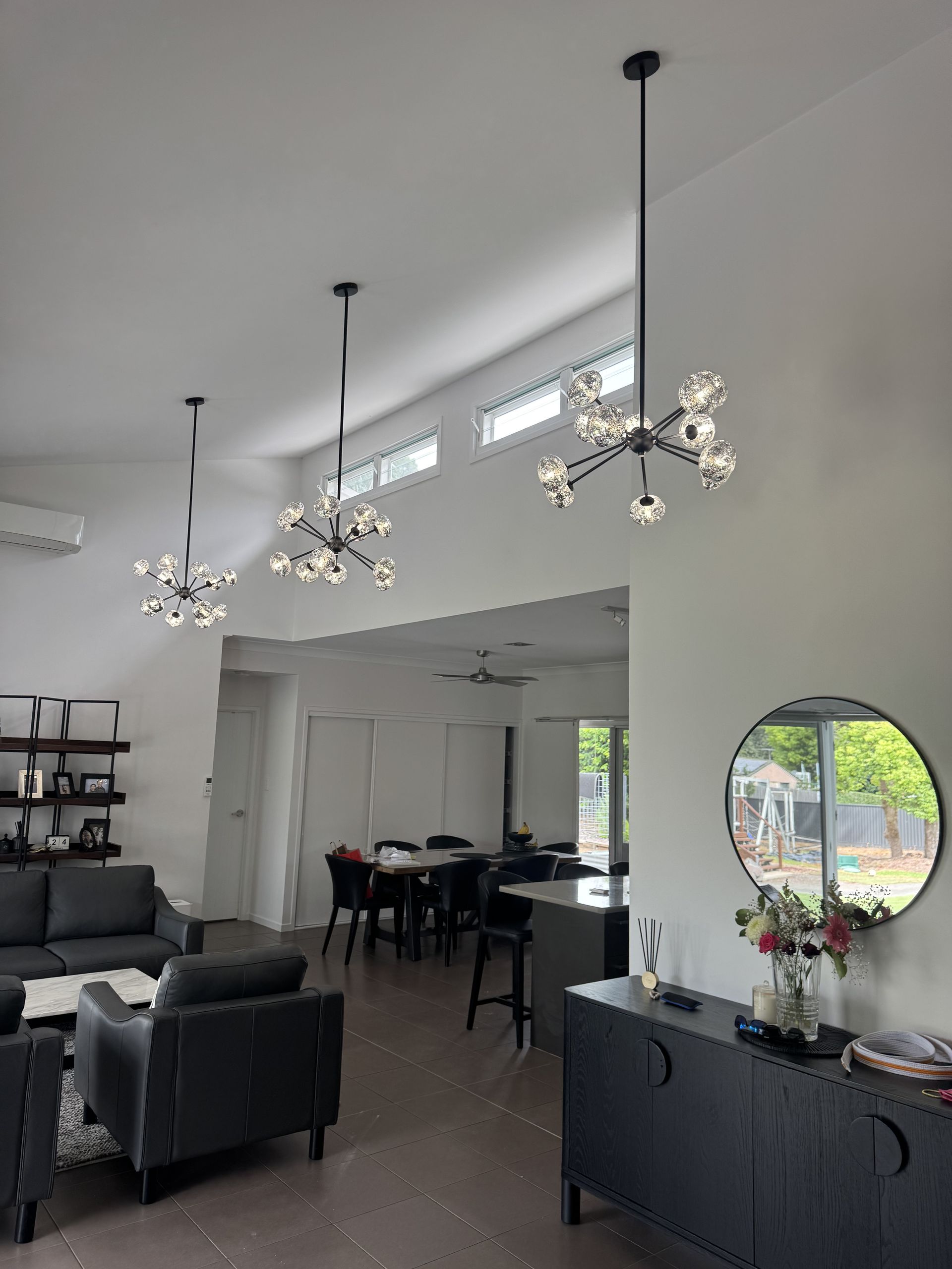 Modern Living Room With Three Starburst Chandeliers — Higgins Electrical in Aura, QLD