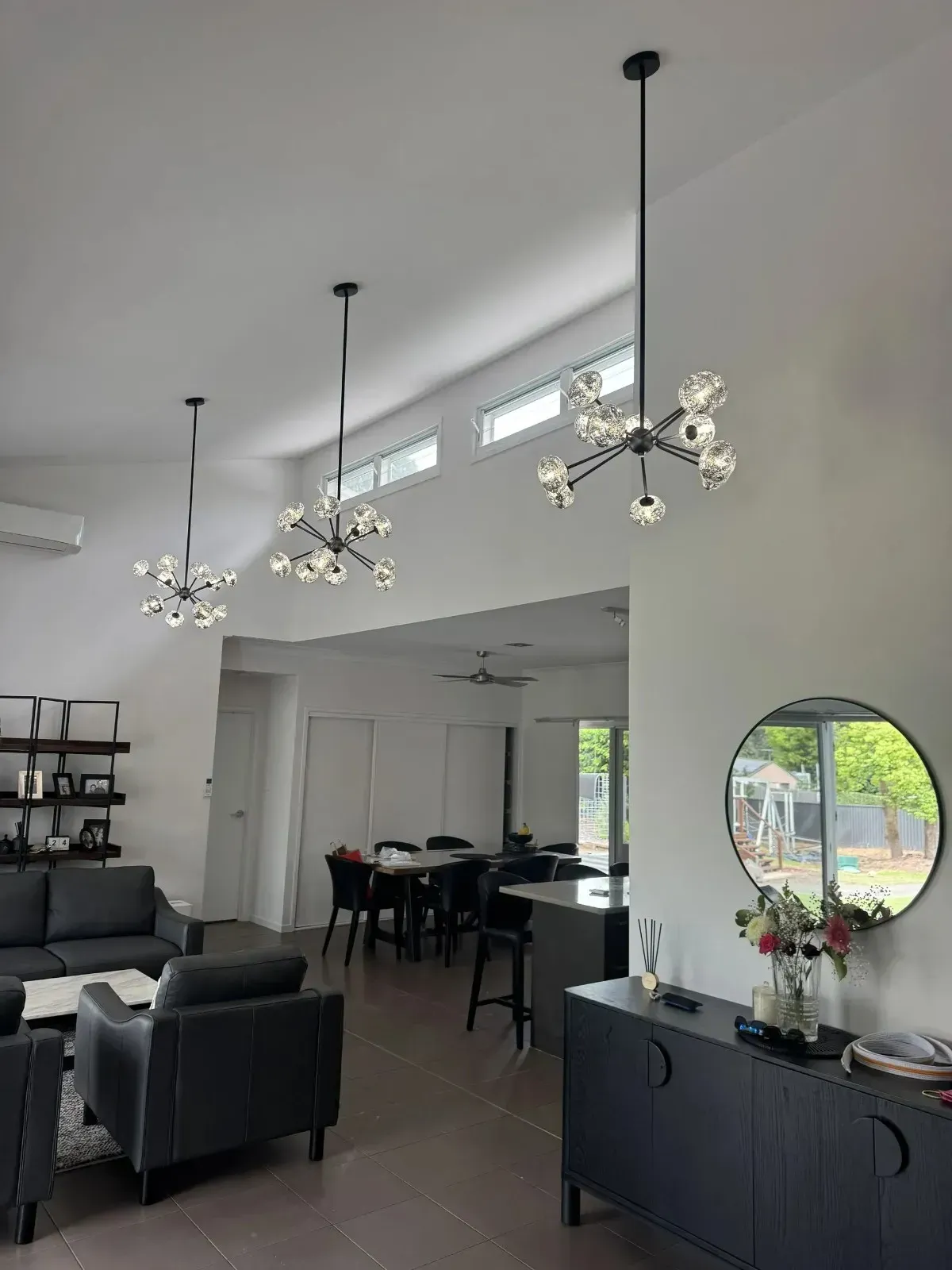 Living Room With Three Modern Chandeliers; Dark Furniture — Higgins Electrical in Beerwah, QLD