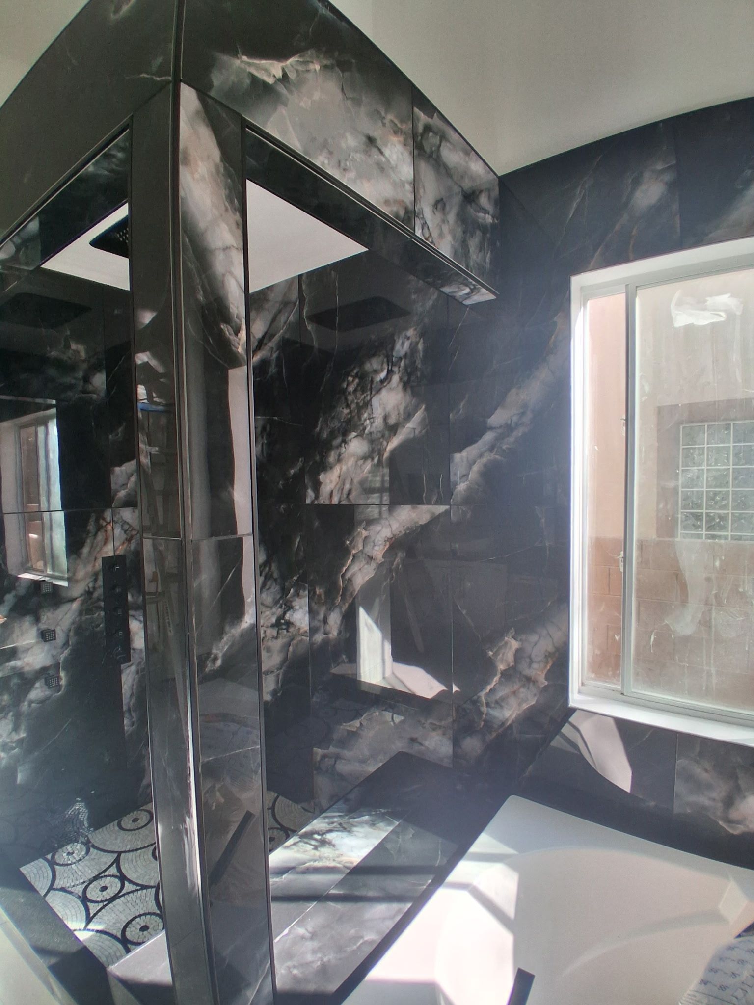 Charred stairwell interior with blackened walls, collapsed steps, and smoke damage near a window