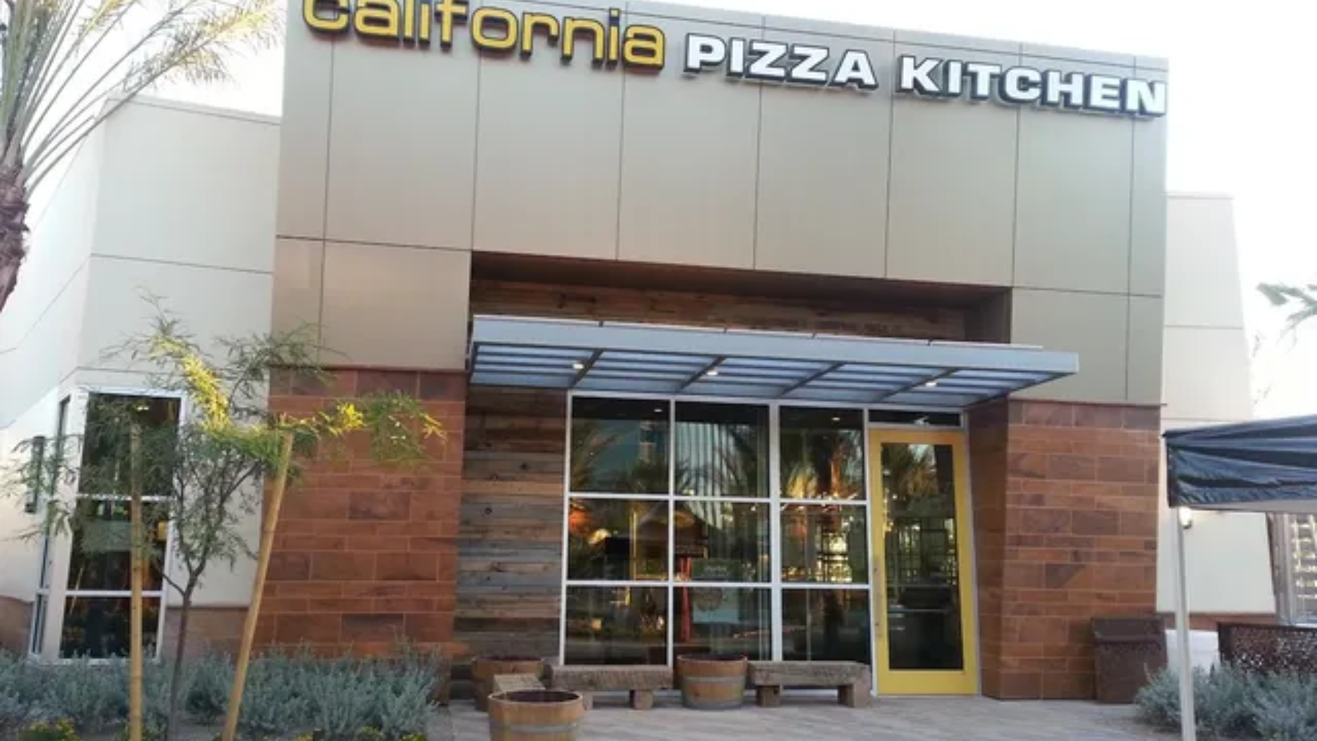 California Pizza Kitchen storefront with glass entrance and awning at a shopping center