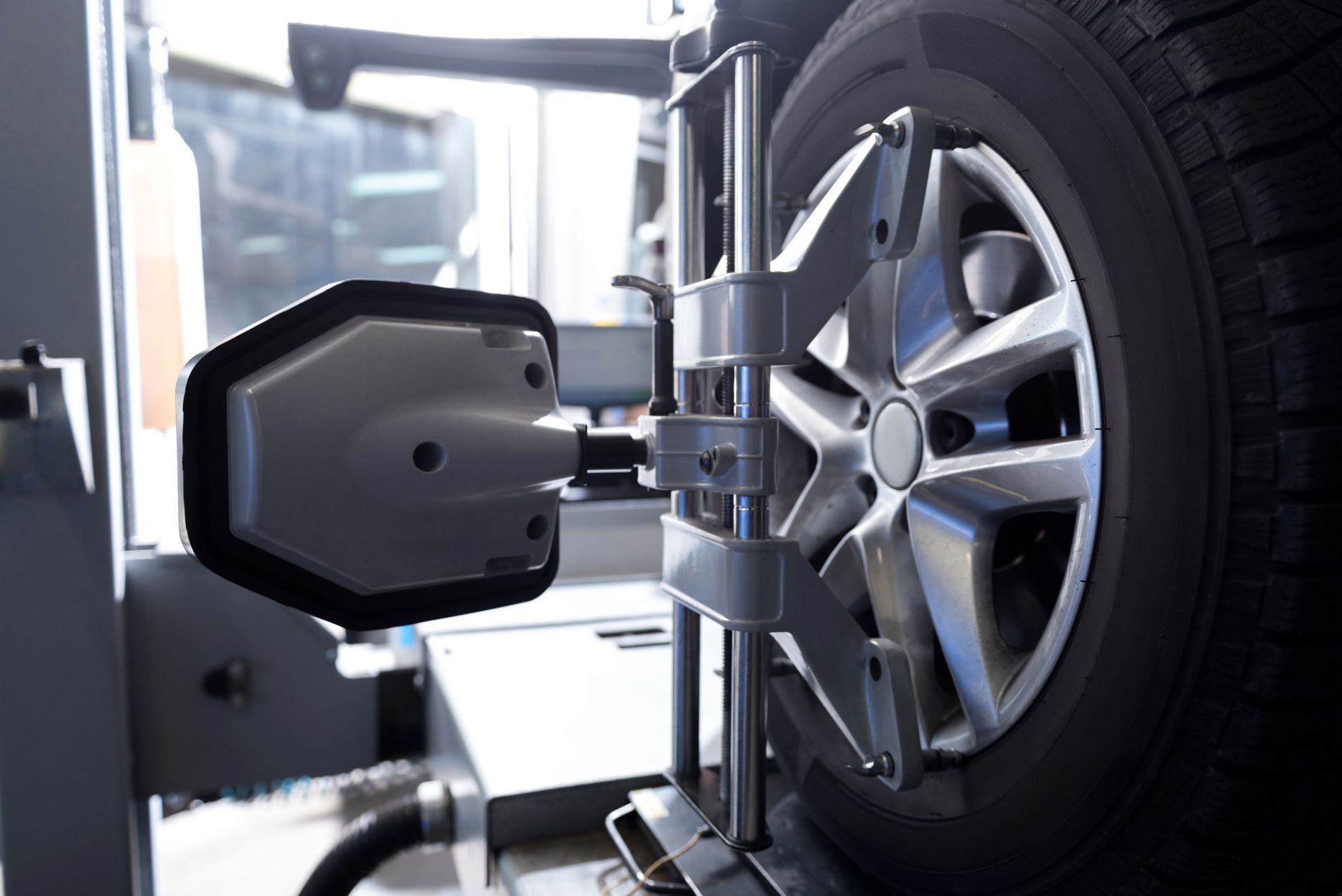 A car wheel is being adjusted by a machine in a garage | Quantum Calibrations