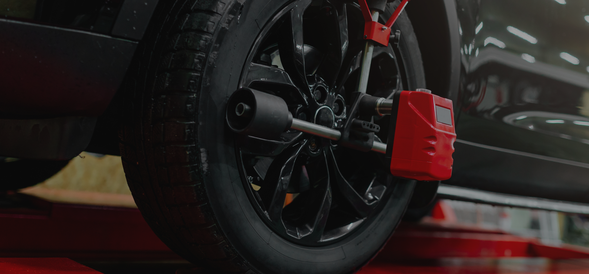A car is being aligned with a machine in a garage | Quantum Calibrations