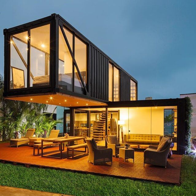 Container houses, also known as container homes, are dwellings built using retired containers. These containers are made of sturdy steel, designed to withstand the harsh conditions of sea transport. Recycling these containers into housing units not only repurposes them but also presents a sustainable and cost-effective solution to the housing crisis A large house with a lot of windows and furniture