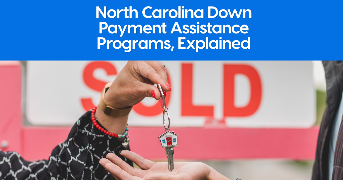 New homeowner receiving house keys on a home keychain in front of a sold sign