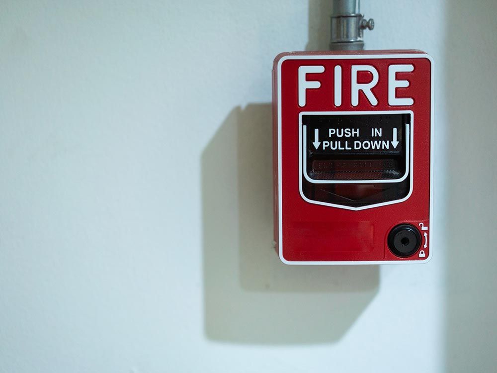 Close Up of a Fire Alarm Signal on Brick Wall Close Up of a Fire Alarm Signal on Brick Wall