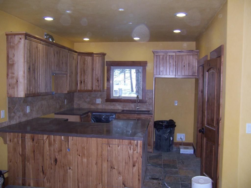 A kitchen with wooden cabinets and granite counter tops