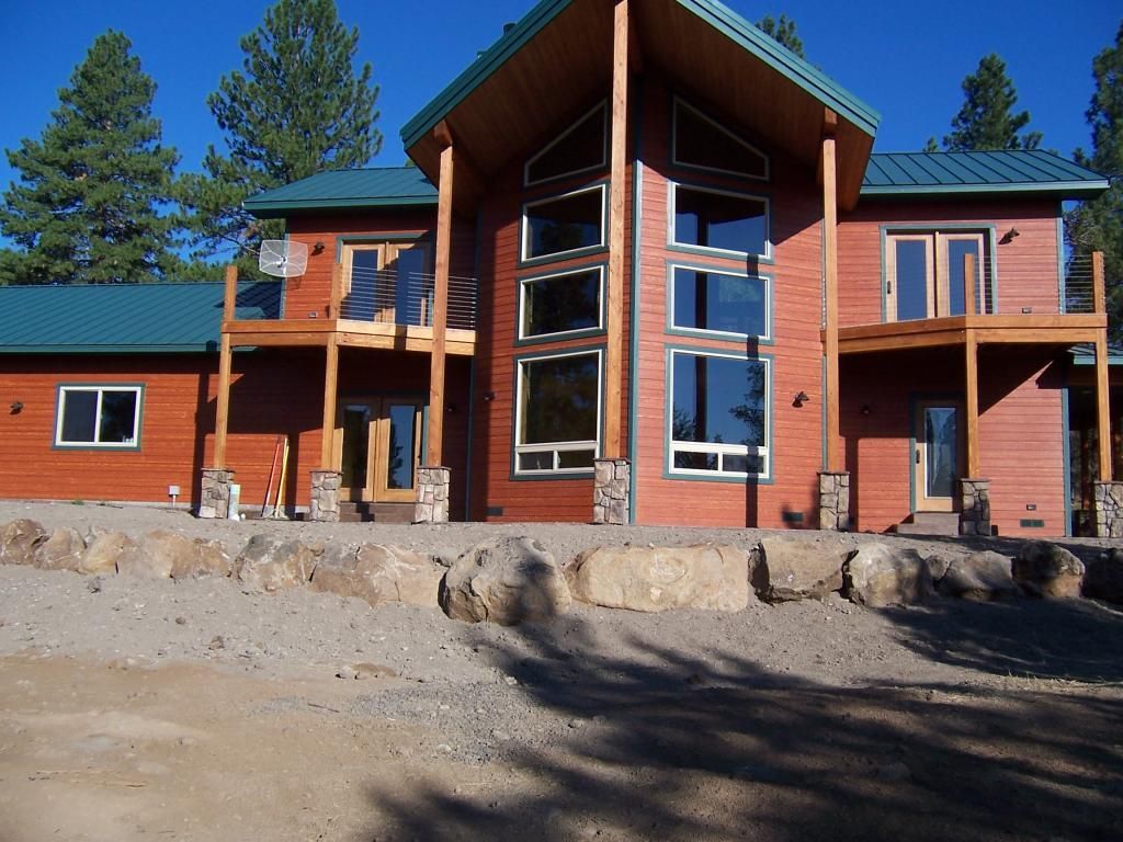 A large house with a green roof and a lot of windows
