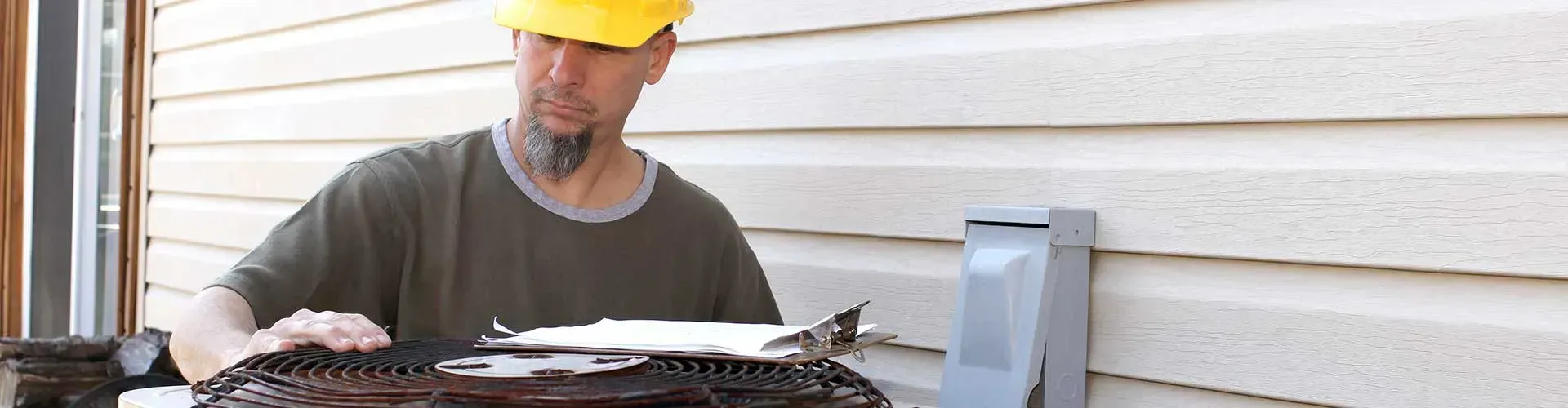 hvac maintenance being done by man in hard hat