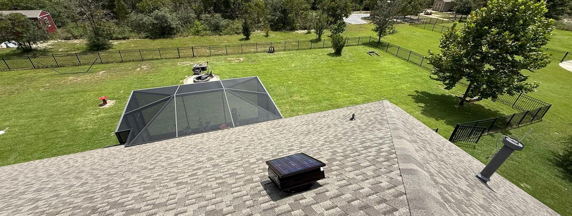 Single-story brick house with white garage, black SUV in driveway, and front lawn on a sunny day