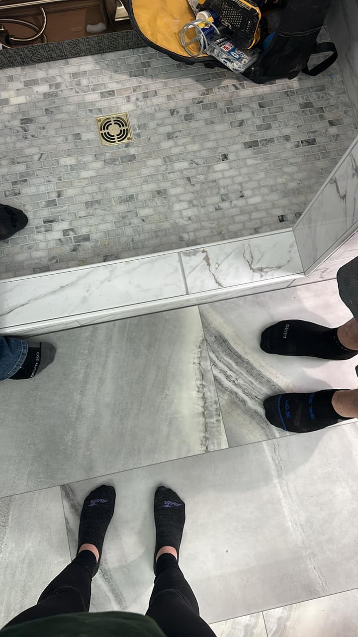 People standing around a concrete pit with a white ledge, viewed from above.