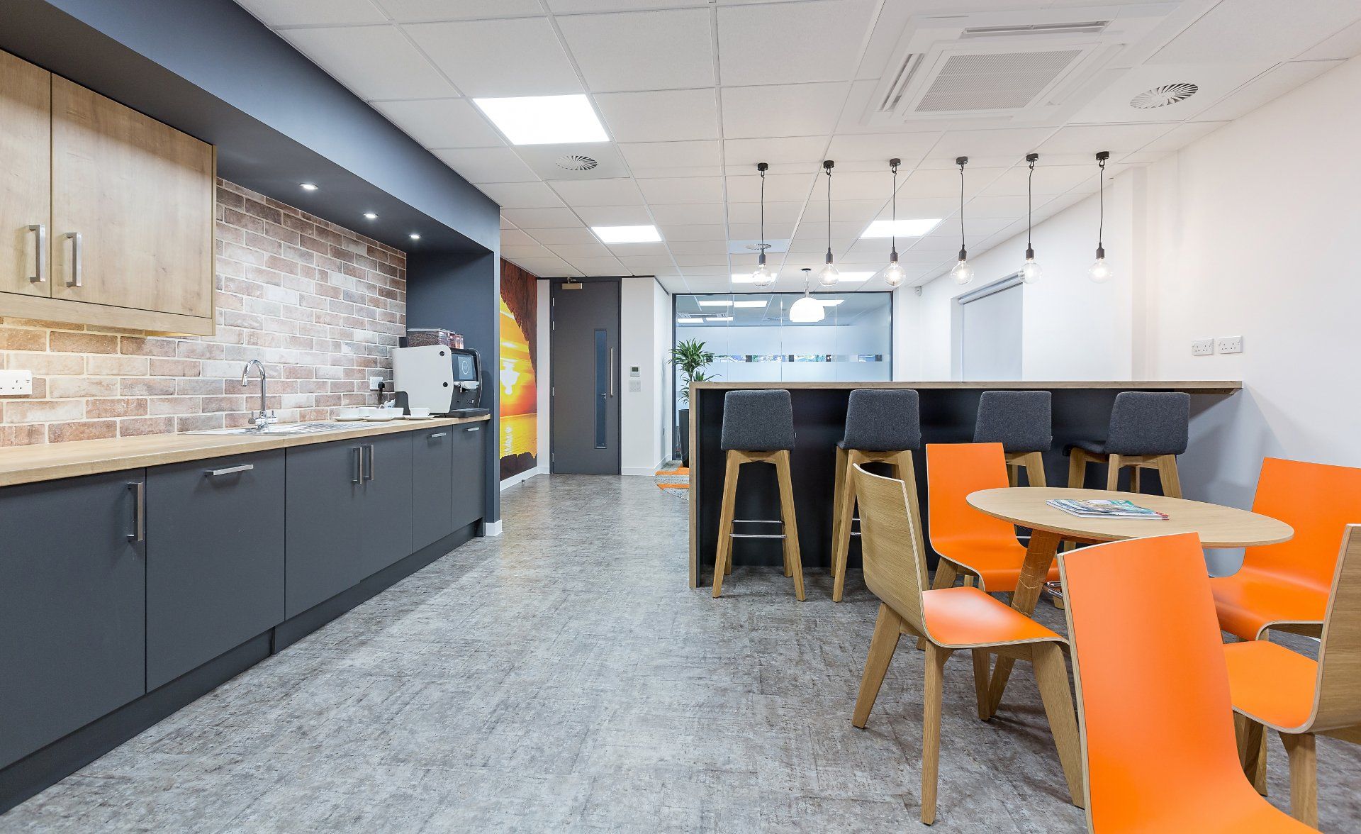 A kitchen with a table and chairs in it.