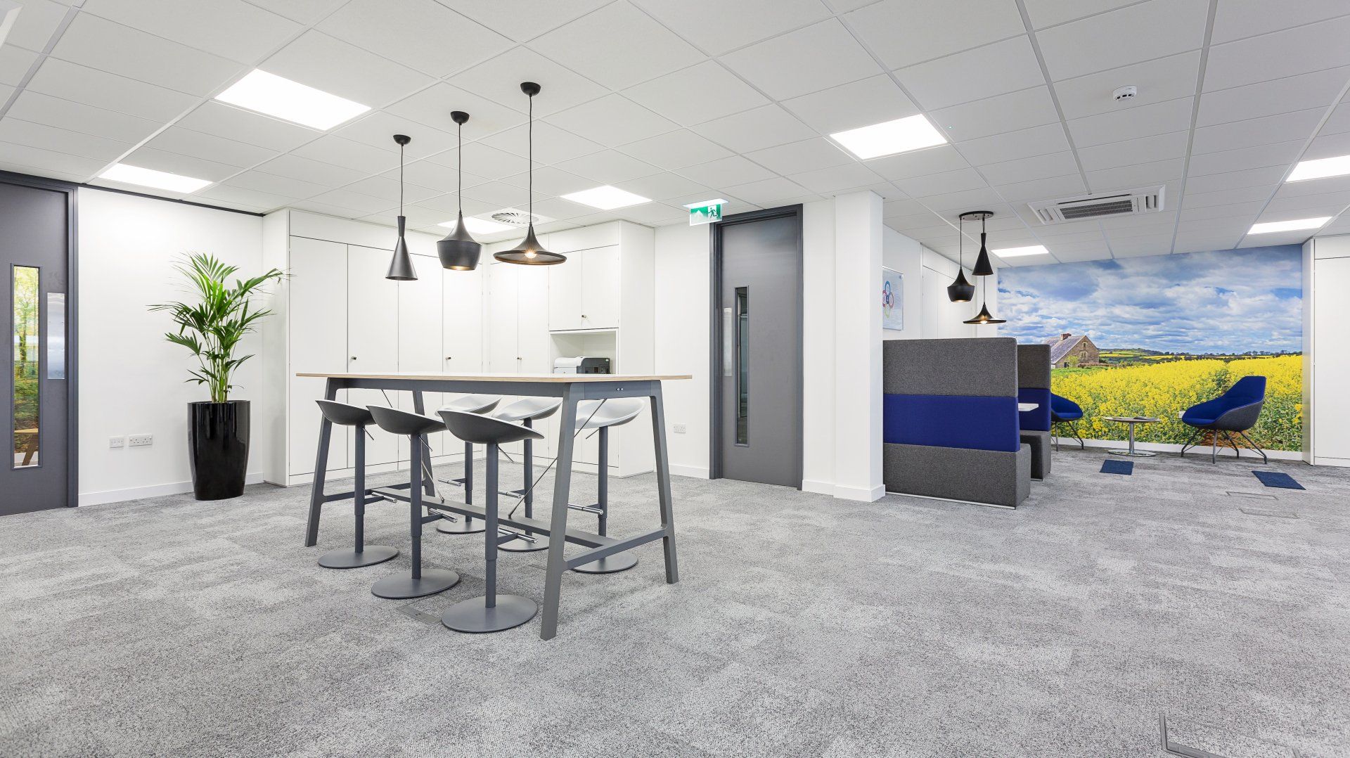 A room with a table and stools in it