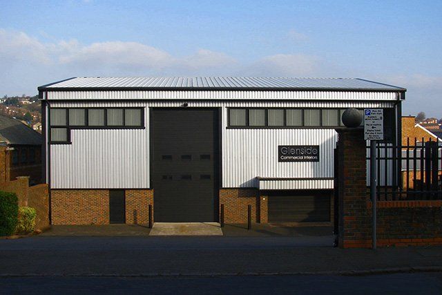 A white building with a black door and a sign that says ' lloyd ' on it