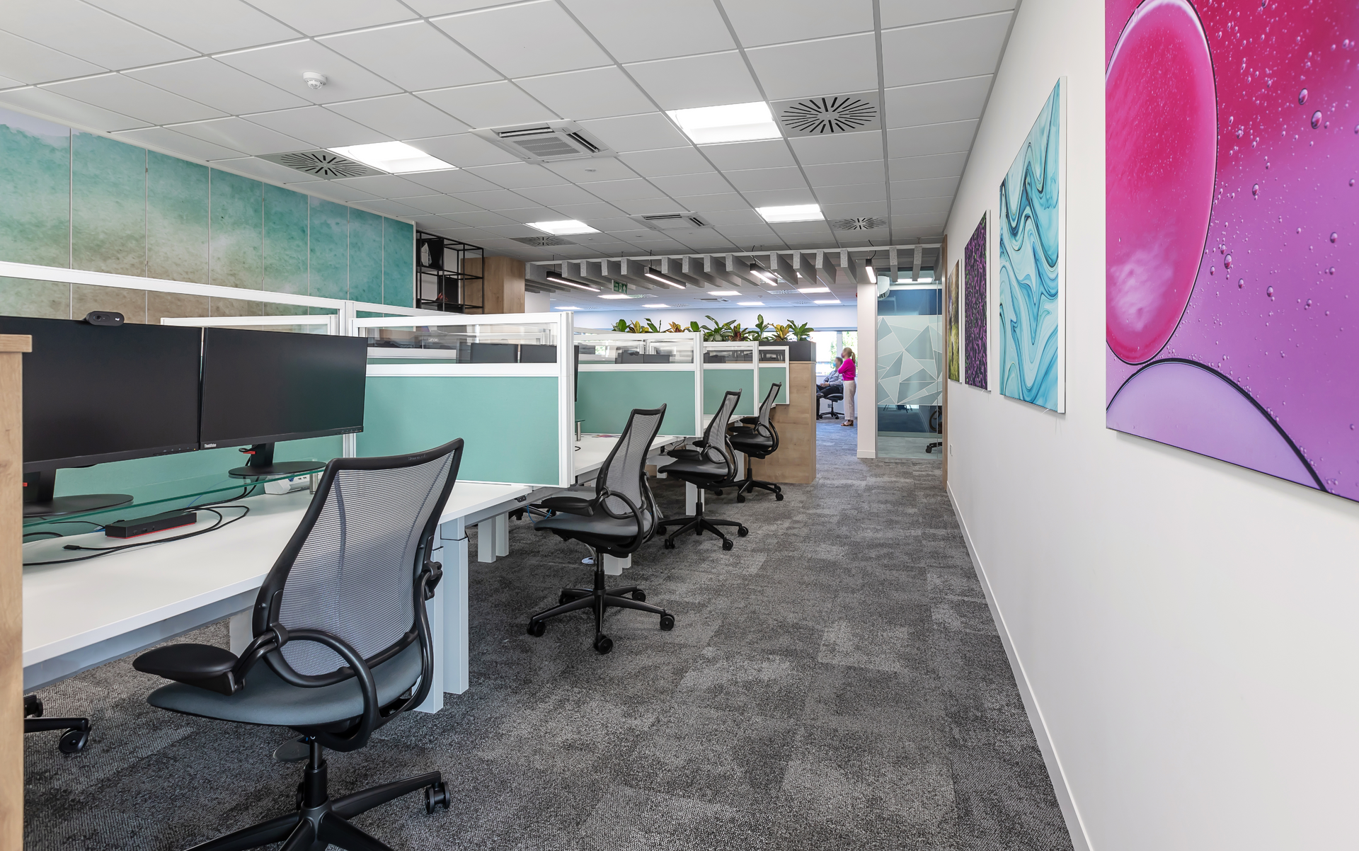 A large office with a lot of desks and chairs.