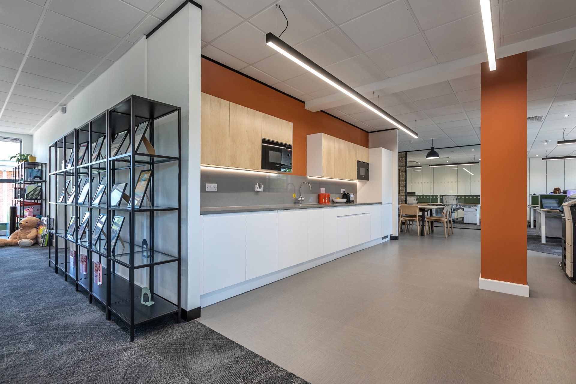 there is a kitchen in the middle of the room .
