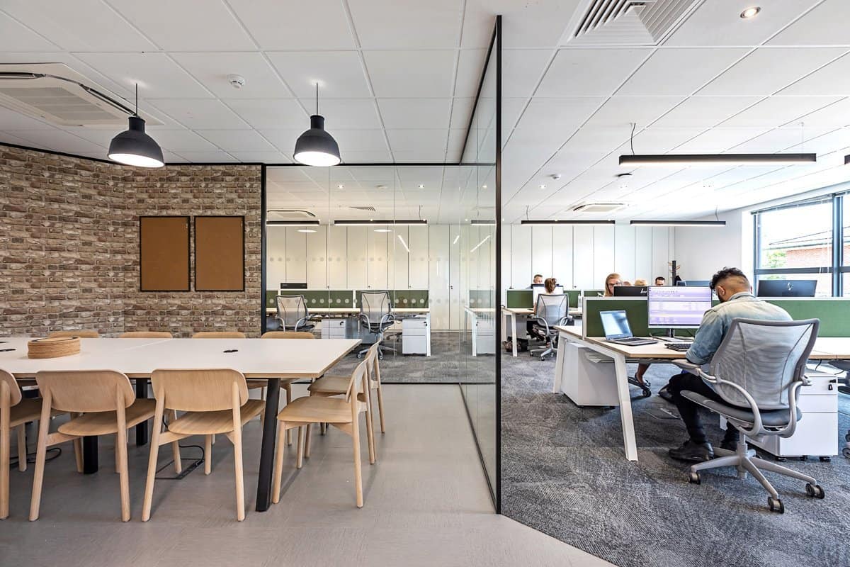 A man is sitting at a desk in an office.