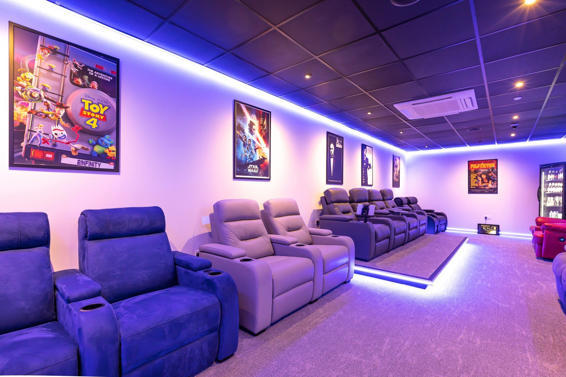 A room with a lot of chairs and a toy story poster on the wall.
