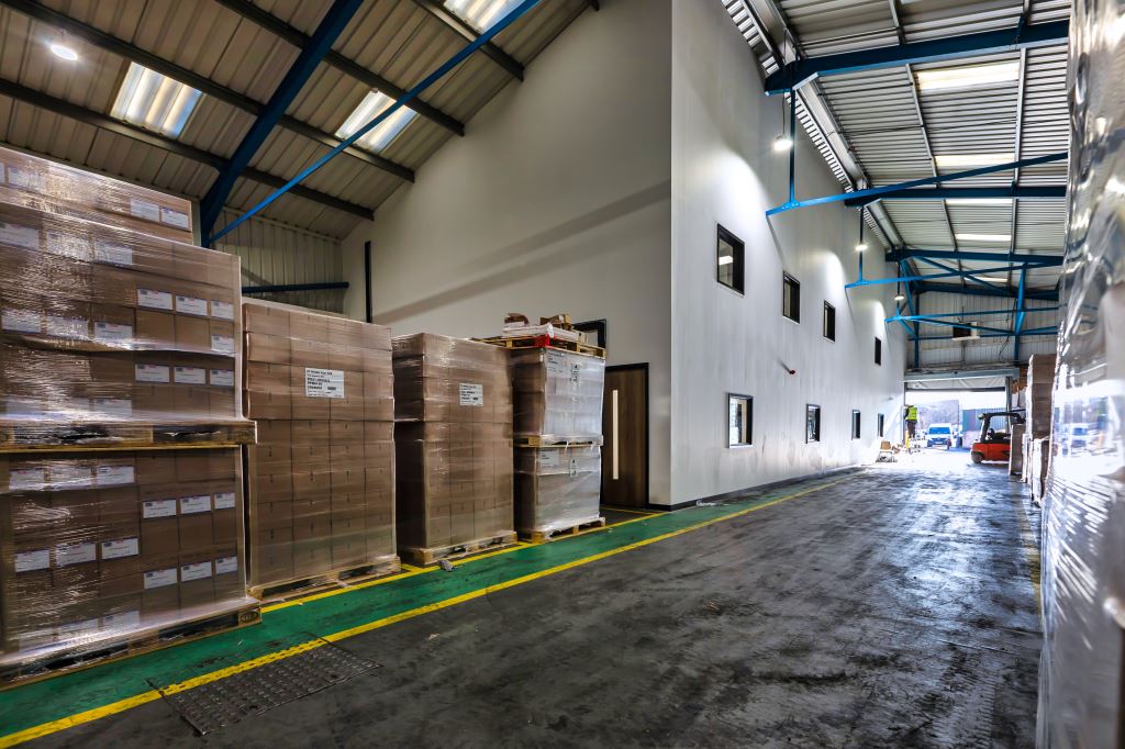 A large warehouse filled with lots of boxes and pallets