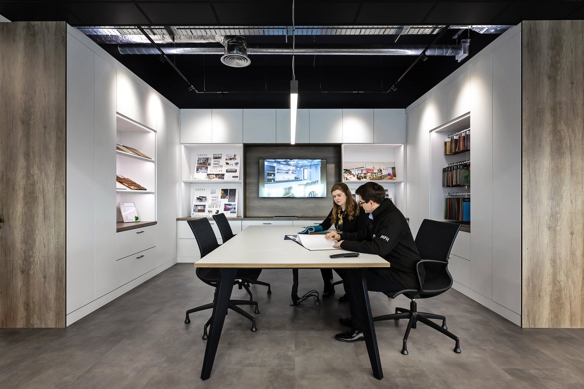 Man and woman conversing in the Glenside design hub.