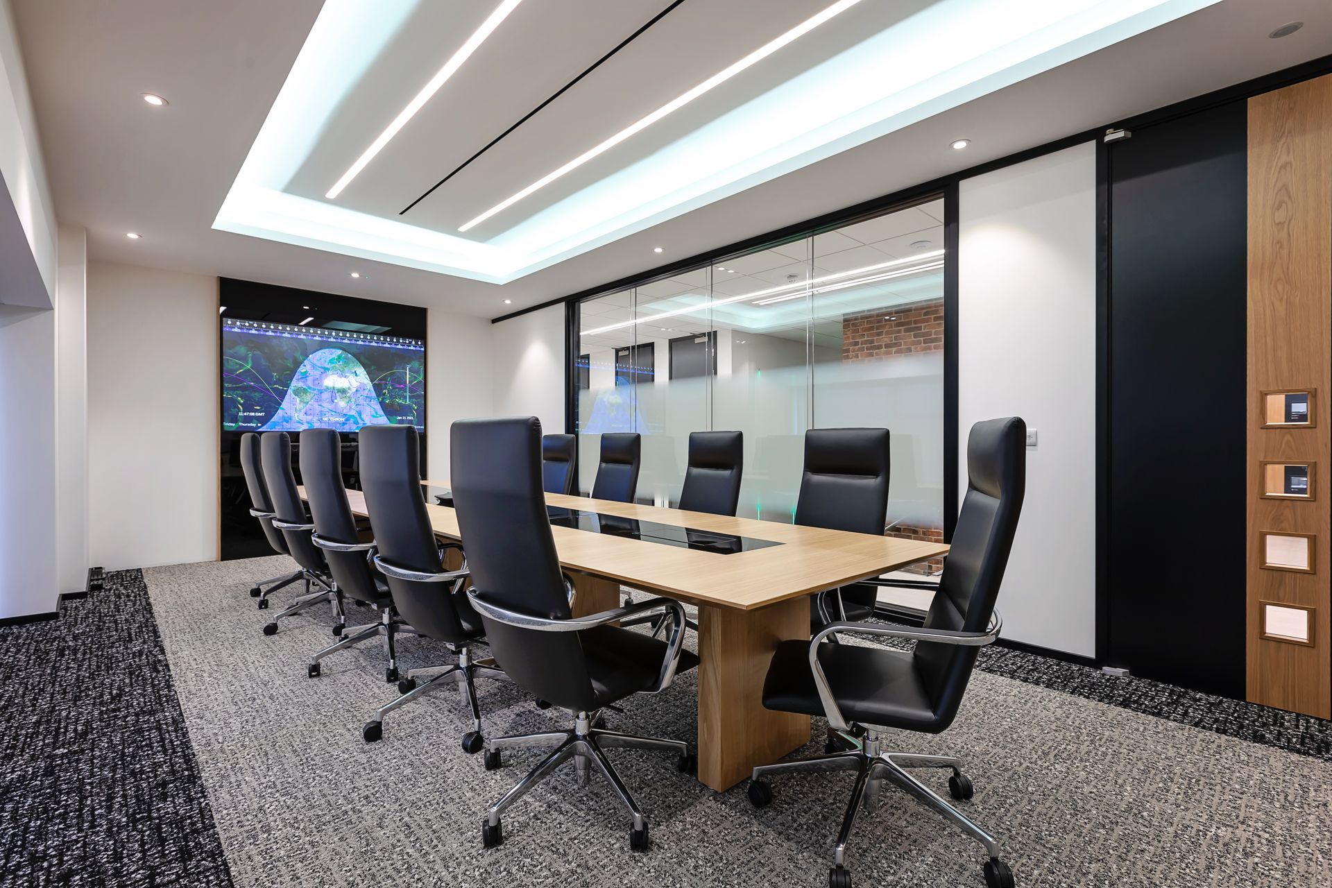 A conference room with a long table and chairs.