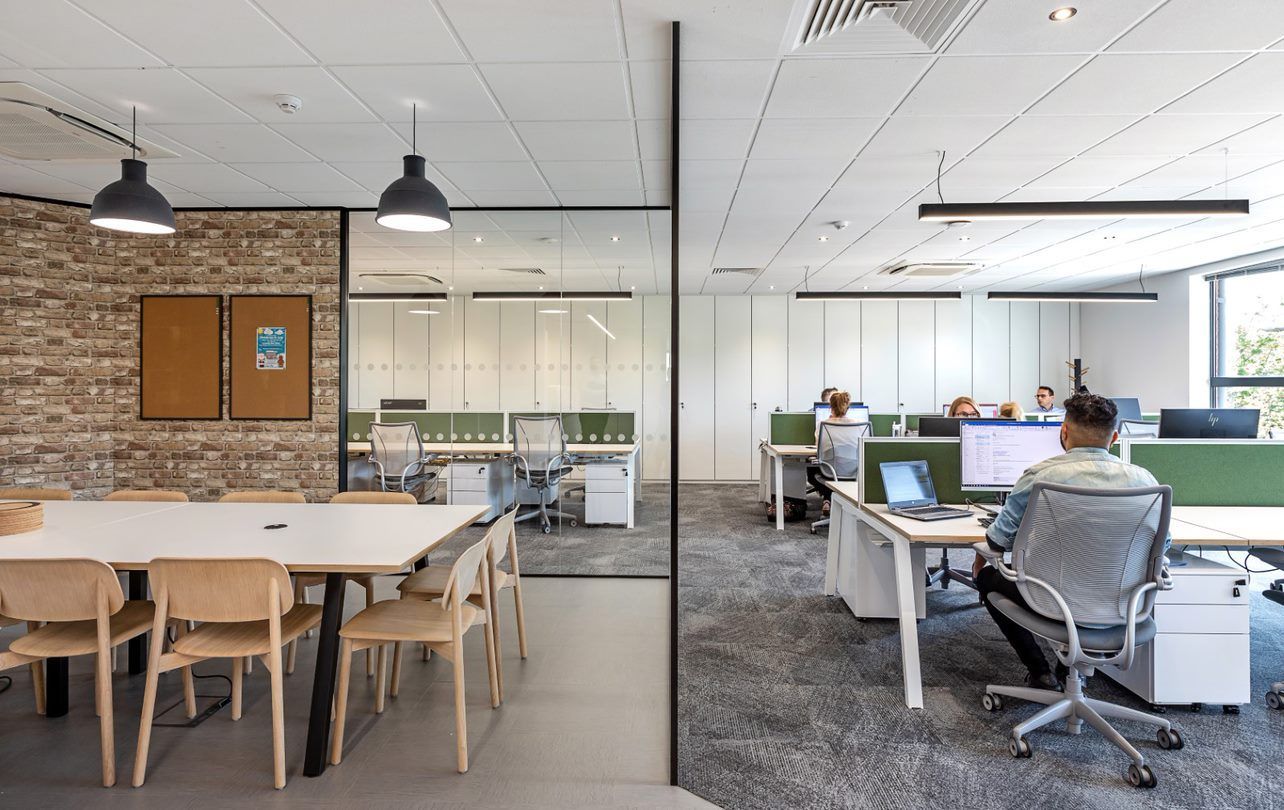 A man is sitting at a desk in an office.