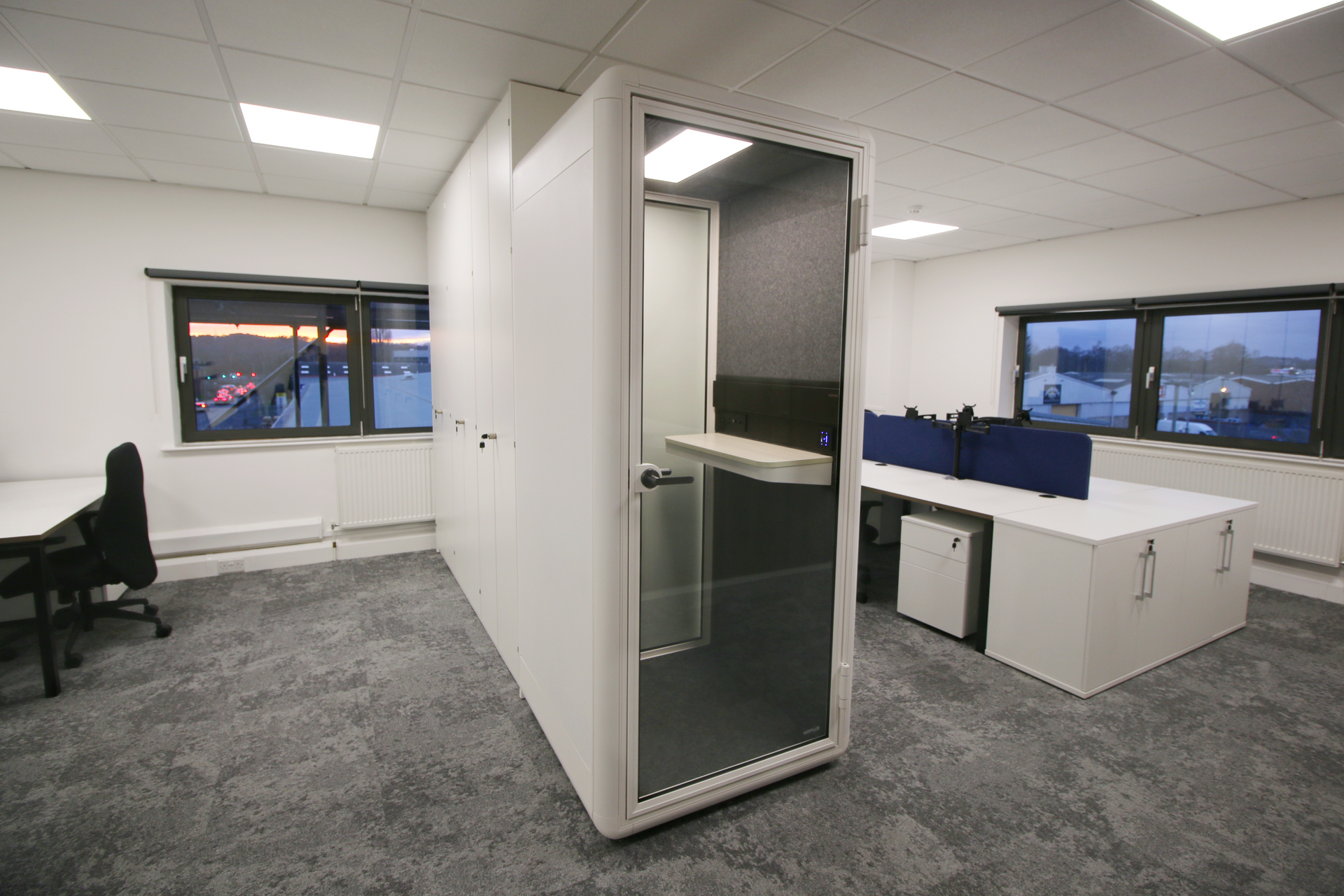 There is a phone booth in the middle of the room.