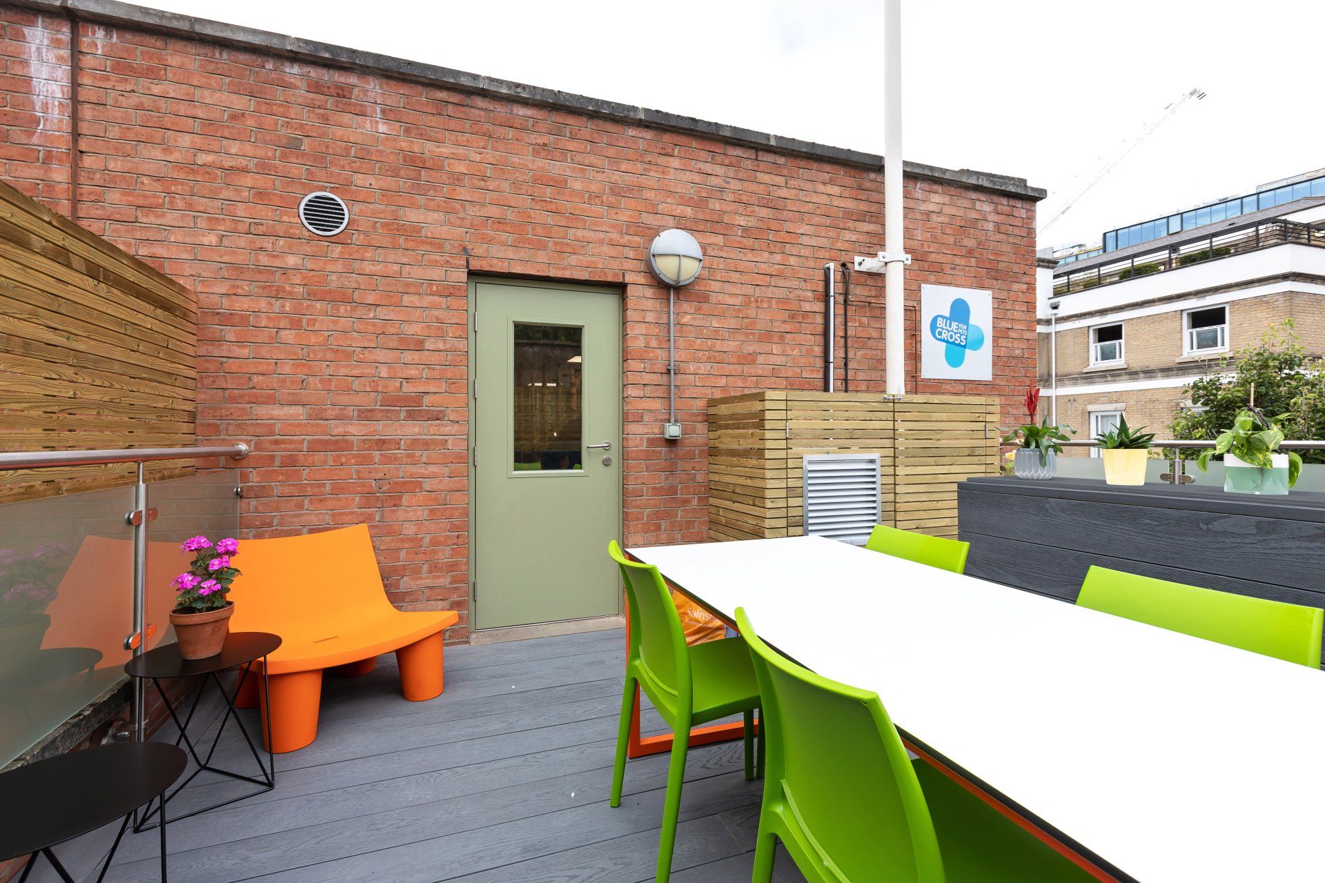 a brick building with a table and chairs in front of it