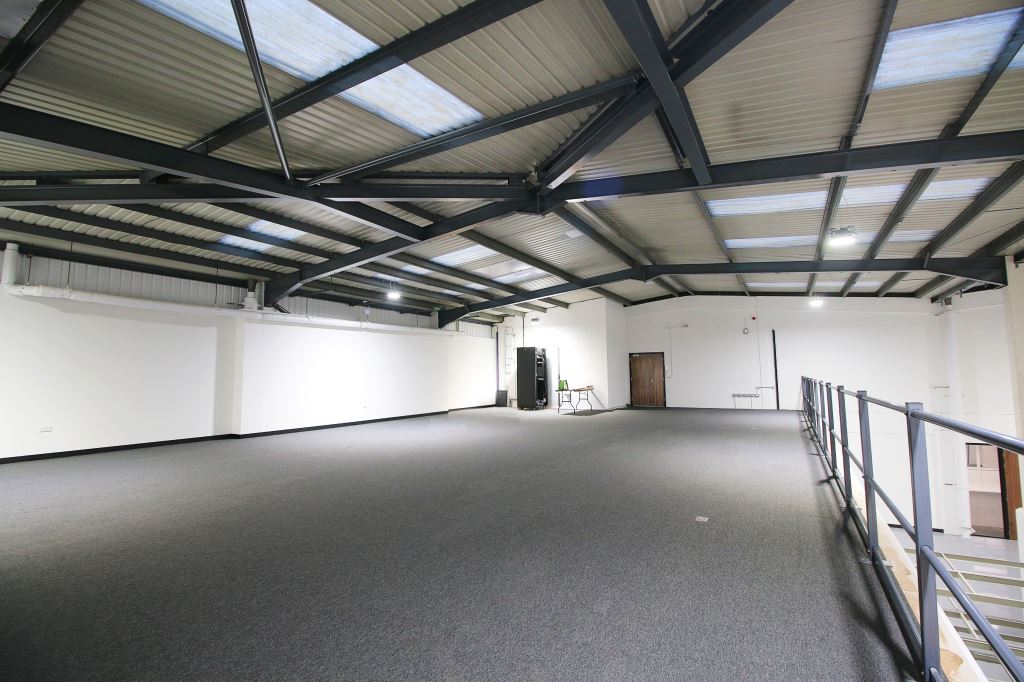 a large empty room with a balcony on the second floor