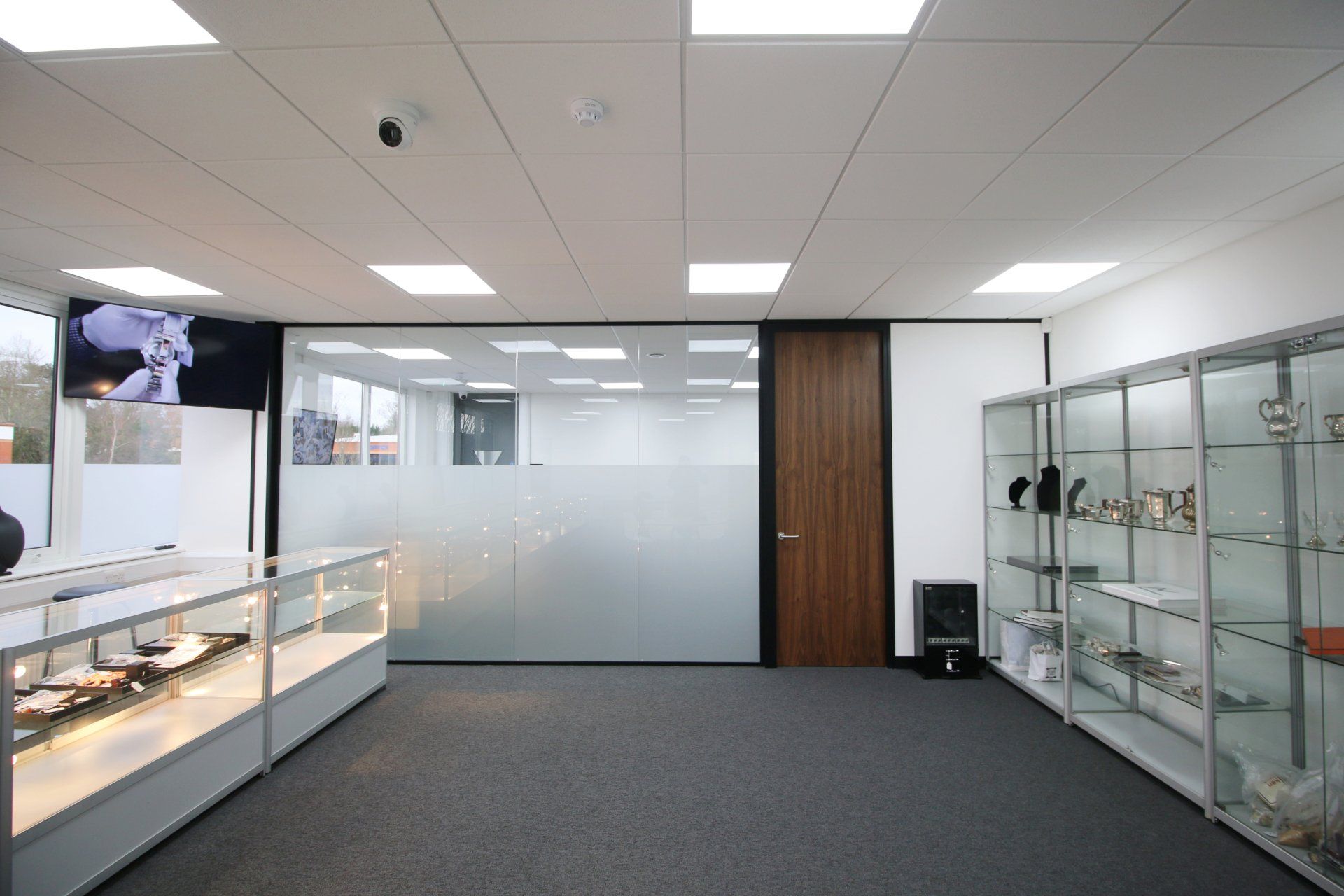 a room with glass shelves and a glass door