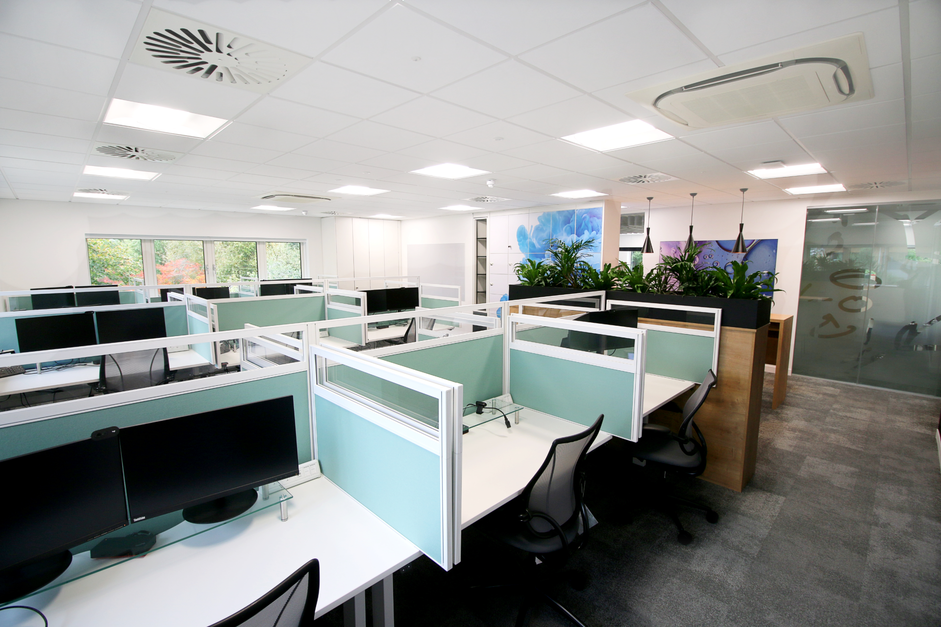 A large office with a lot of desks and chairs.
