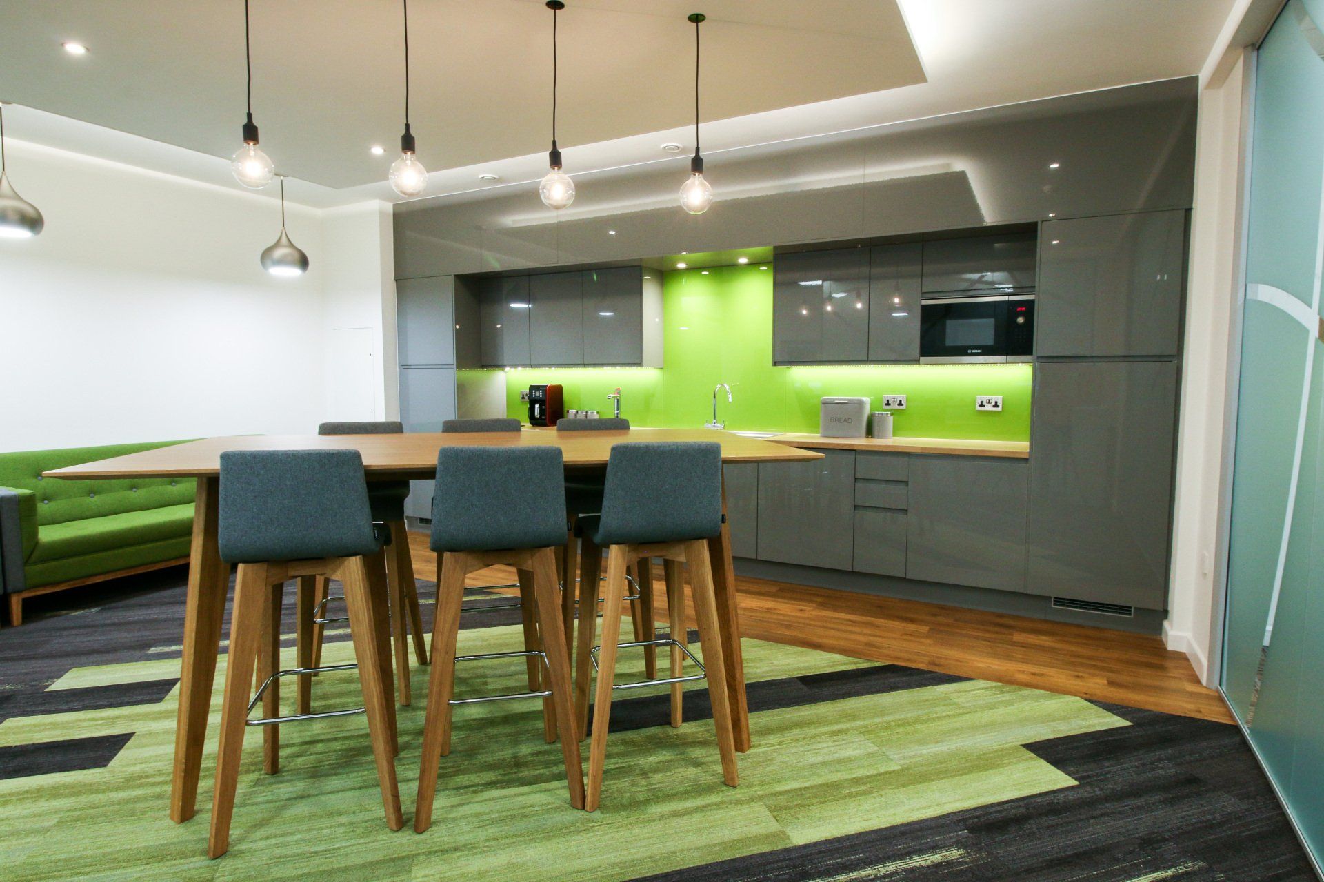 a kitchen with a table and stools in it