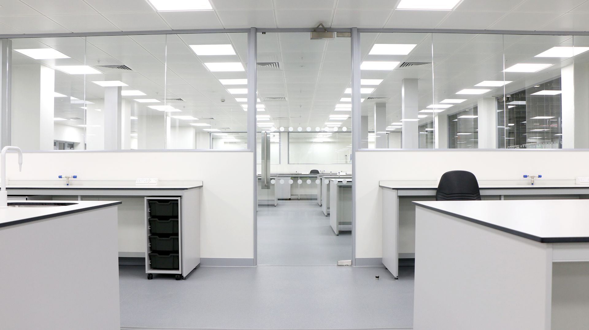 A large empty laboratory with a lot of desks and chairs.