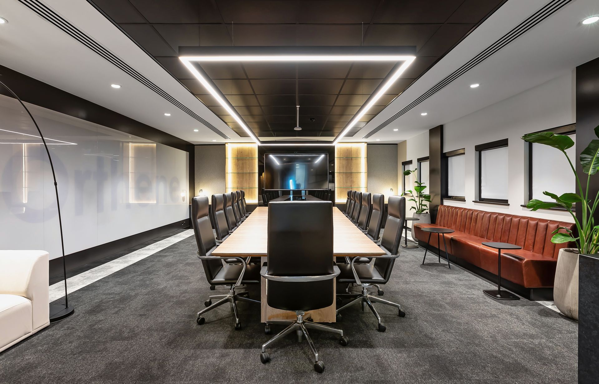 A large conference room with a long table and chairs.