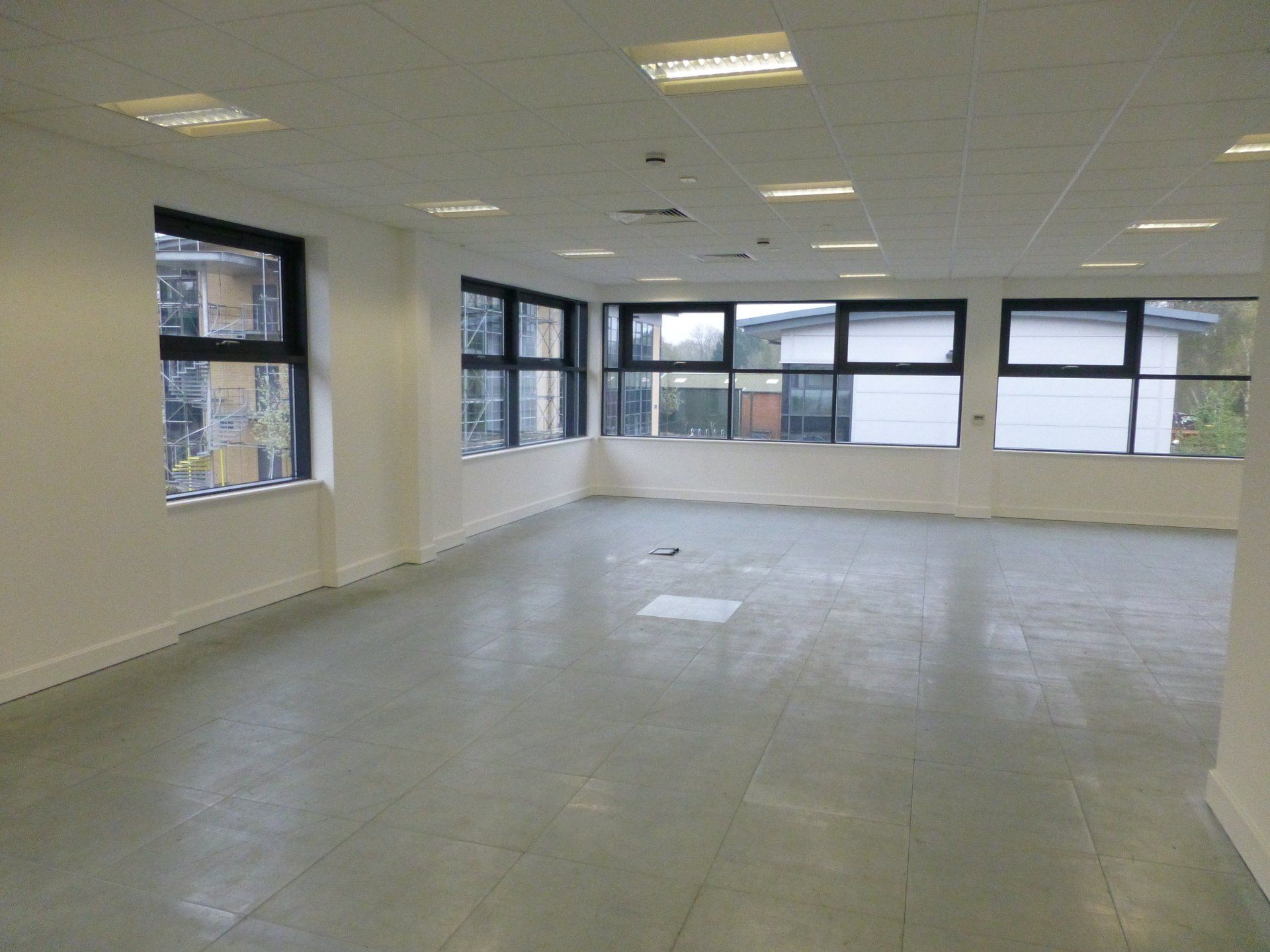 A large empty room with a lot of windows