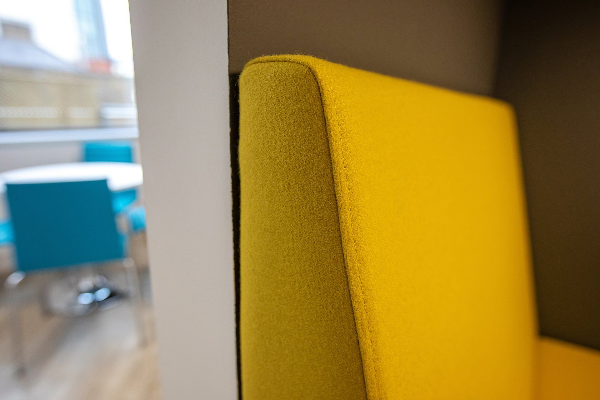 A close up of a yellow chair in a room.