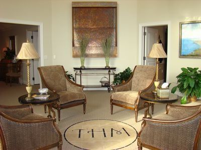 Lounge area with four armchairs around a circular rug with 