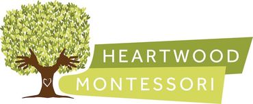 A logo for heartwood montessori with a tree in the middle
