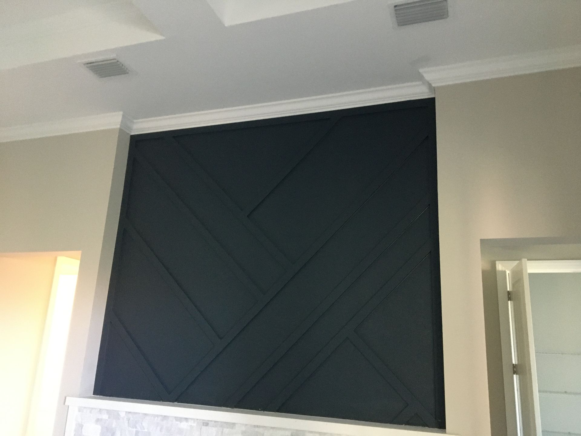 Interior feature wall with custom residential exterior painting in a dark accent color for a modern home design.